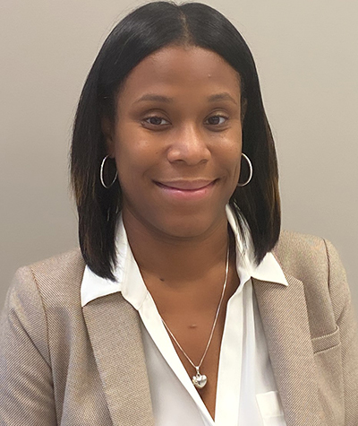 Professional woman smiling in business attire.