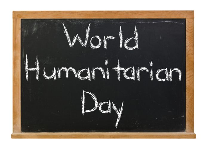 Chalkboard with 'World Humanitarian Day' written in white chalk.