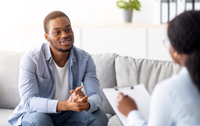Man conversing with counselor during therapy session