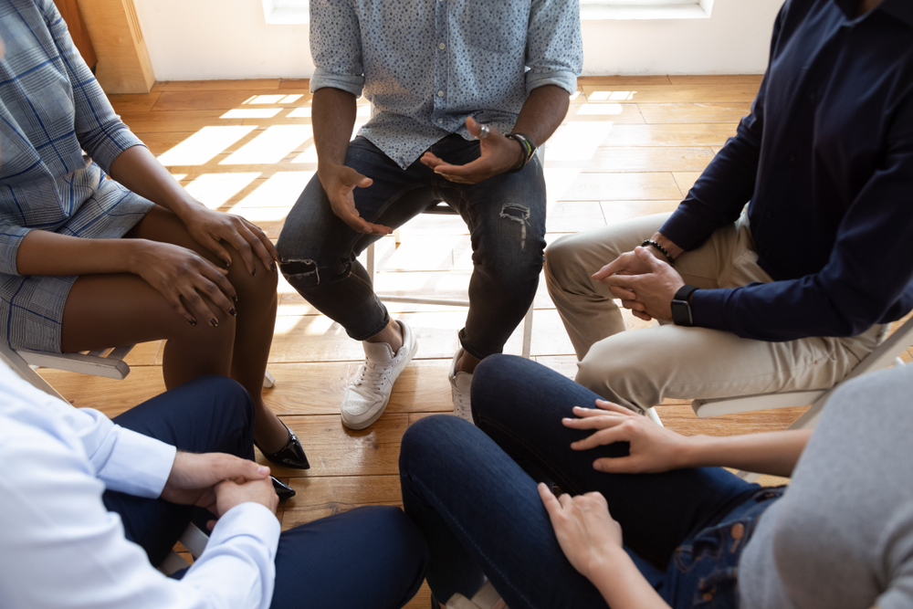 Support group meeting, participants seated in circle