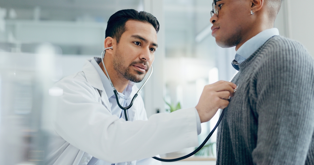Doctor examining patient with stethoscope